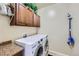 Efficient laundry room featuring modern LG appliances and ample cabinet space, with a functional and organized design at 2872 Dreamcatcher Loop, Castle Rock, CO 80109