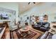 Open-concept living area with a leather sofa, patterned armchairs, and seamless flow to the kitchen at 2872 Dreamcatcher Loop, Castle Rock, CO 80109
