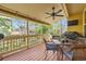 Covered porch featuring a dining table with seating and an outdoor ceiling fan overlooking a well-maintained backyard at 2872 Dreamcatcher Loop, Castle Rock, CO 80109