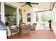Covered porch features outdoor dining set, ceiling fan, and views of the backyard, perfect for relaxation at 2872 Dreamcatcher Loop, Castle Rock, CO 80109