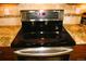 Modern stainless steel stove with a black glass top and granite countertop at 2872 Dreamcatcher Loop, Castle Rock, CO 80109