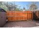 Backyard with a patio, wood fence, storage shed, and partial view of foliage at 15107 E Wesley Ave, Aurora, CO 80014