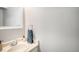 Cozy bathroom with light cream vanity, faucet and mirror; neutral colored walls; and towel rack at 15107 E Wesley Ave, Aurora, CO 80014