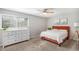 Bedroom featuring a large sunny window, large dresser, neutral walls and carpet, and eye catching bed at 15107 E Wesley Ave, Aurora, CO 80014