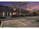 Brick townhomes feature well-manicured lawns and parking spaces during a dusk sky at 15107 E Wesley Ave, Aurora, CO 80014