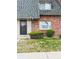 Charming townhouse exterior features a well-maintained lawn, bushes, and a welcoming front door at 15107 E Wesley Ave, Aurora, CO 80014