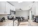 Modern kitchen features stainless steel appliances and an adjacent dining area at 15107 E Wesley Ave, Aurora, CO 80014