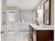 Spacious bathroom featuring a double vanity, marble floors, and white subway tile at 210 S High St, Denver, CO 80209