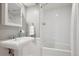Classic bathroom featuring a pedestal sink, white tile, and a shower with a curtain at 210 S High St, Denver, CO 80209