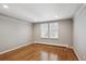 This bedroom is spacious with neutral paint, wood floors, and natural light from the dual shuttered windows at 210 S High St, Denver, CO 80209