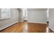 A serene bedroom featuring warm hardwood floors, crisp white trim, and shuttered windows at 210 S High St, Denver, CO 80209