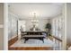 Formal dining room featuring hardwood floors, a modern chandelier, and access to the kitchen and outdoor patio at 210 S High St, Denver, CO 80209