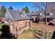 Charming two-story brick home featuring a quaint brick courtyard, mature trees, and a classic architectural style at 210 S High St, Denver, CO 80209