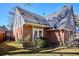Charming brick home with gray siding and mature landscaping on a sunny day at 210 S High St, Denver, CO 80209