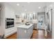 Modern kitchen featuring white cabinetry, stainless steel appliances, a central island, and hardwood floors at 210 S High St, Denver, CO 80209