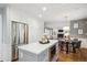 Bright kitchen with an island, stainless steel appliances, and hardwood floors at 210 S High St, Denver, CO 80209