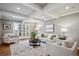 Bright and inviting living room with neutral tones, hardwood floors, coffered ceilings, and French doors to the backyard at 210 S High St, Denver, CO 80209