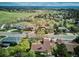 Scenic aerial shot showcasing a peaceful neighborhood with tree-lined streets, well-maintained homes, and lush green spaces at 14072 W Alaska Dr, Lakewood, CO 80228