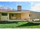 A cozy backyard featuring a patio, a charming chimney, and a well-manicured lawn for outdoor relaxation at 14072 W Alaska Dr, Lakewood, CO 80228