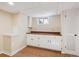 Basement kitchenette area features bright cabinetry, wood countertop, and a window for natural light at 14072 W Alaska Dr, Lakewood, CO 80228