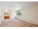 Spacious bedroom with carpeted floors, ensuite bathroom, and a large window view at 14072 W Alaska Dr, Lakewood, CO 80228