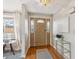 Inviting entryway showcases hardwood floors, a decorative front door, and stylish console table at 14072 W Alaska Dr, Lakewood, CO 80228