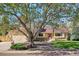 Charming single-Gathering home showcasing a well-maintained front yard, mature trees, and a welcoming facade at 14072 W Alaska Dr, Lakewood, CO 80228