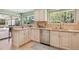 Well-lit kitchen featuring stainless steel appliances, granite countertops, and ample cabinet space at 14072 W Alaska Dr, Lakewood, CO 80228