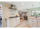 Spacious kitchen with stainless appliances, granite counters, and seamless transition to the living area at 14072 W Alaska Dr, Lakewood, CO 80228