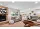 Cozy living room features a brick fireplace, comfortable seating, and an open layout at 14072 W Alaska Dr, Lakewood, CO 80228