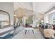 Bright living room featuring vaulted ceilings, large windows, neutral decor, and comfortable seating at 14072 W Alaska Dr, Lakewood, CO 80228