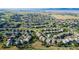 Expansive aerial view showcases a sprawling residential community nestled in rolling hills at 651 Tiger Lily Way, Highlands Ranch, CO 80126