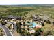 Aerial view featuring resort style pool, clubhouse, and recreation area amid lush landscaping at 651 Tiger Lily Way, Highlands Ranch, CO 80126