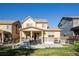 The backyard with patio boasts an outdoor kitchen, dining area and seating at 651 Tiger Lily Way, Highlands Ranch, CO 80126