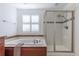 Bright bathroom featuring a soaking tub, glass shower, and tiled accents at 651 Tiger Lily Way, Highlands Ranch, CO 80126