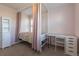 Bright bedroom featuring a charming canopy bed, white desk, and a storage cabinet for a cozy retreat at 651 Tiger Lily Way, Highlands Ranch, CO 80126