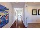 Inviting hallway with hardwood floors leading to a bright dining area at 651 Tiger Lily Way, Highlands Ranch, CO 80126