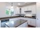 Bright kitchen featuring white cabinets, granite counters, and hardwood floors at 651 Tiger Lily Way, Highlands Ranch, CO 80126