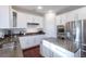 White kitchen featuring stainless steel appliances, granite counters, and a center island at 651 Tiger Lily Way, Highlands Ranch, CO 80126