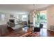 Bright and open living space with a fireplace, modern lighting, and access to the outdoor patio at 651 Tiger Lily Way, Highlands Ranch, CO 80126