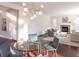 Open-concept living and dining area with hardwood floors and a cozy fireplace at 651 Tiger Lily Way, Highlands Ranch, CO 80126