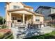 A spacious patio includes an outdoor kitchen, dining area and comfortable seating at 651 Tiger Lily Way, Highlands Ranch, CO 80126