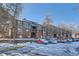 Front view of building with parking lot and snow at 3576 S Depew St # 104, Denver, CO 80235