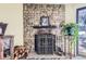 Stone fireplace with ornate screen and wood storage at 3576 S Depew St # 104, Denver, CO 80235