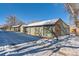 Attached garages with snow-covered driveway at 3576 S Depew St # 104, Lakewood, CO 80235