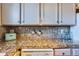 Kitchen counter with granite top and built-in appliances at 3576 S Depew St # 104, Lakewood, CO 80235