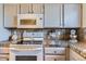 Bright kitchen features granite countertops and modern appliances at 3576 S Depew St # 104, Denver, CO 80235