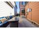 Paver patio with seating, a BBQ, and string lights, offering a cozy outdoor space for entertaining at 1928 W 67Th Pl, Denver, CO 80221