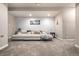 Spacious basement with carpet and comfortable seating for relaxation at 1928 W 67Th Pl, Denver, CO 80221