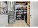 Unfinished basement with essential utilities neatly arranged, including the furnace and storage shelves at 1928 W 67Th Pl, Denver, CO 80221